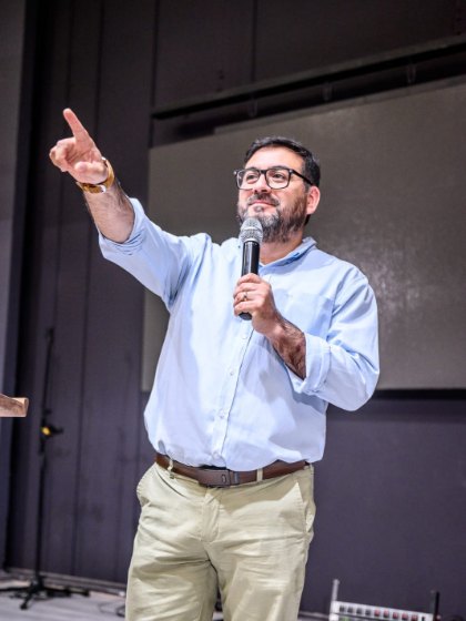 Boris González hablando con micrófono durante una conferencia